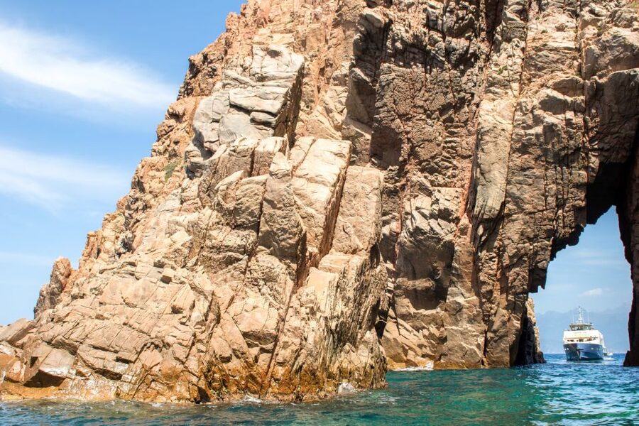 From Porto: Scandola & Girolata Tour by Boat - Scandola by water, with red cliffs and seabirds