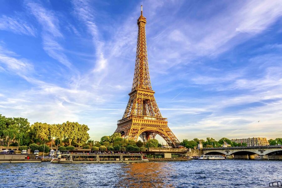 Paris: Eiffel Tower Access by Elevator & Seine River Cruise - Entering the Eiffel Tower with a guide
