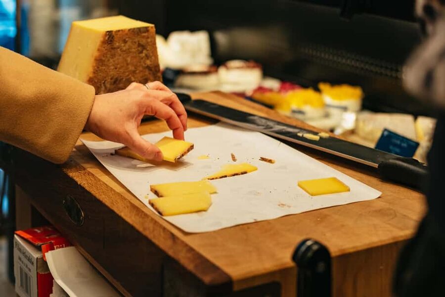 Paris: Gourmet Food Tour with Over 10 Tastings and Wine - Historic market streets and a family brioche shop